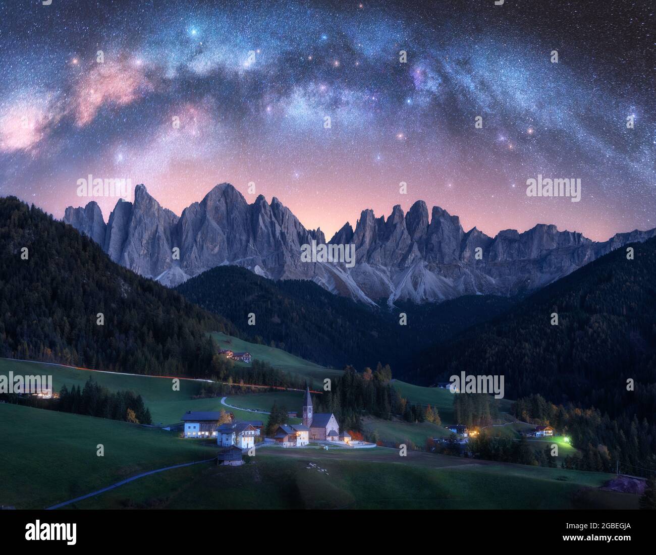 Santa Maddalena and acrhed Milky Way at night in summer in Italy Stock Photo