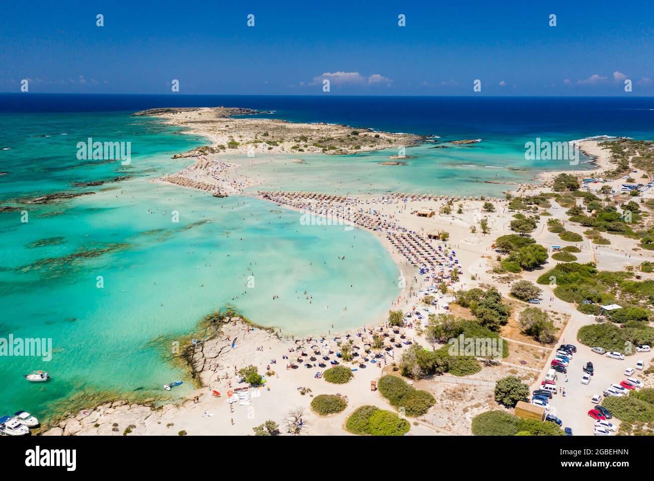 Aerial view of shallow sandy lagoons and a beach surrounded by deeper dark blue sea (Elafonissi Beach) Stock Photo