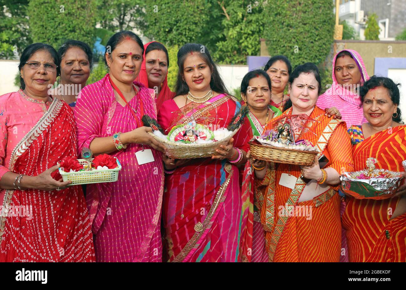 Beawar, India. 02nd Aug, 2021. Hindu women wearing colorful lahariya saree, pose for a picture with the idols of Laddu Gopal (Lord Krishna) as they celebrate the holy month of Sawan (Shravan) in Beawar. (Photo by Sumit Saraswat/Pacific Press) Credit: Pacific Press Media Production Corp./Alamy Live News Stock Photo