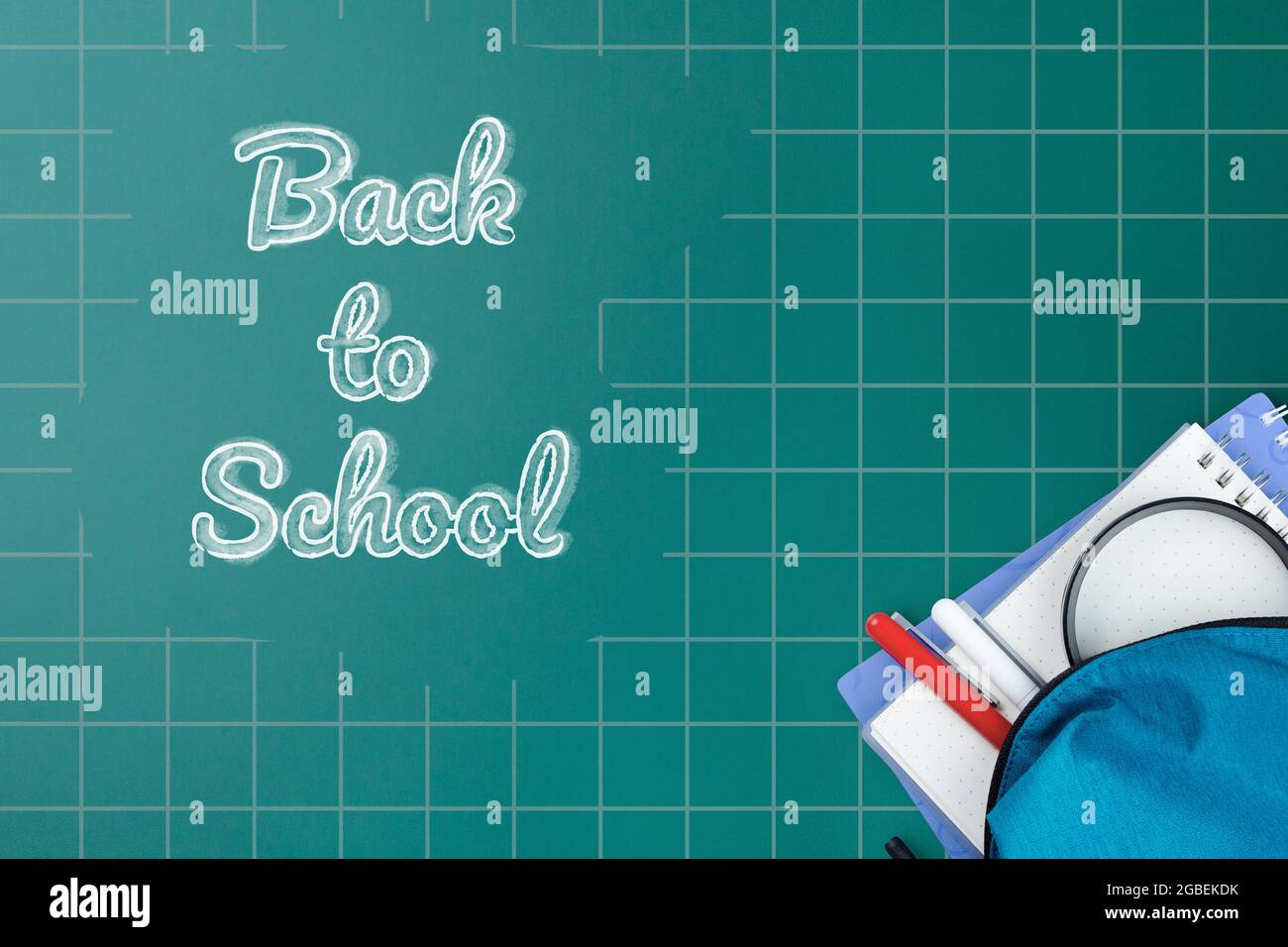 School backpack with stationery on desk. Stock Photo