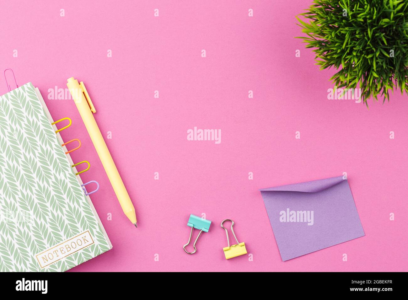 Notepad with pen on pink background. Stock Photo