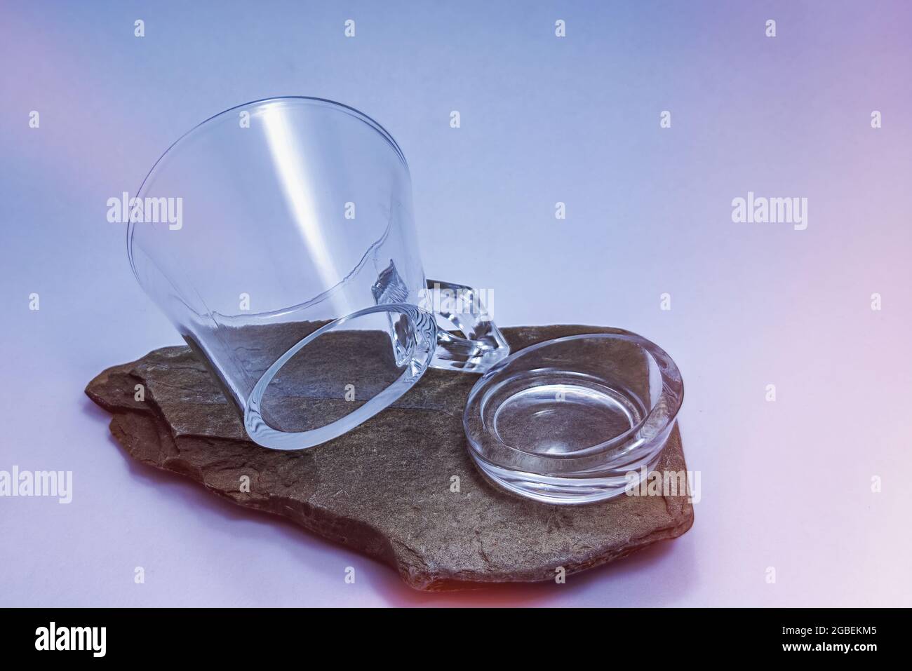 Glass mug broken by its base on slate Stock Photo