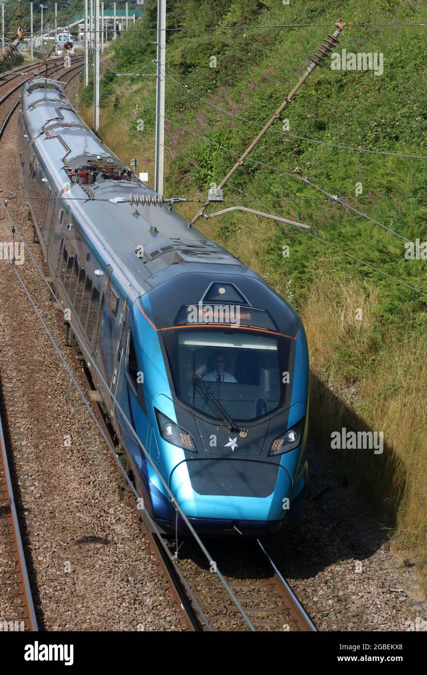 TransPennine Express Nova 2 electric train passing Hest Bank on West Coast Main Line railway, 3rd August 2021, with express passenger service. Stock Photo