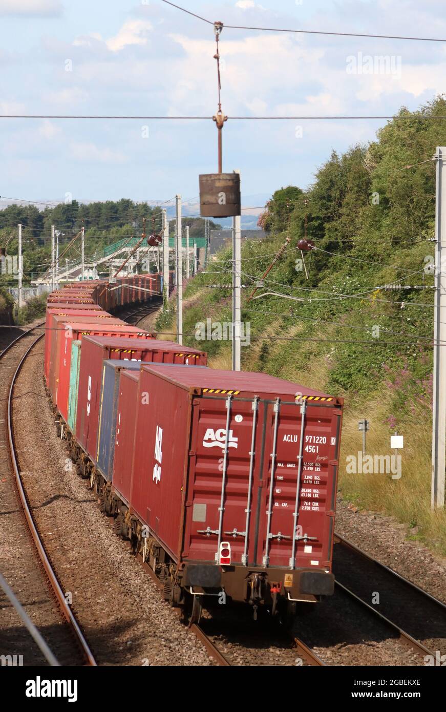 Rear end of diesel hauled container train passing through Hest Bank, Lancashire on West Coast Main Line, 3rd August 2021. Stock Photo
