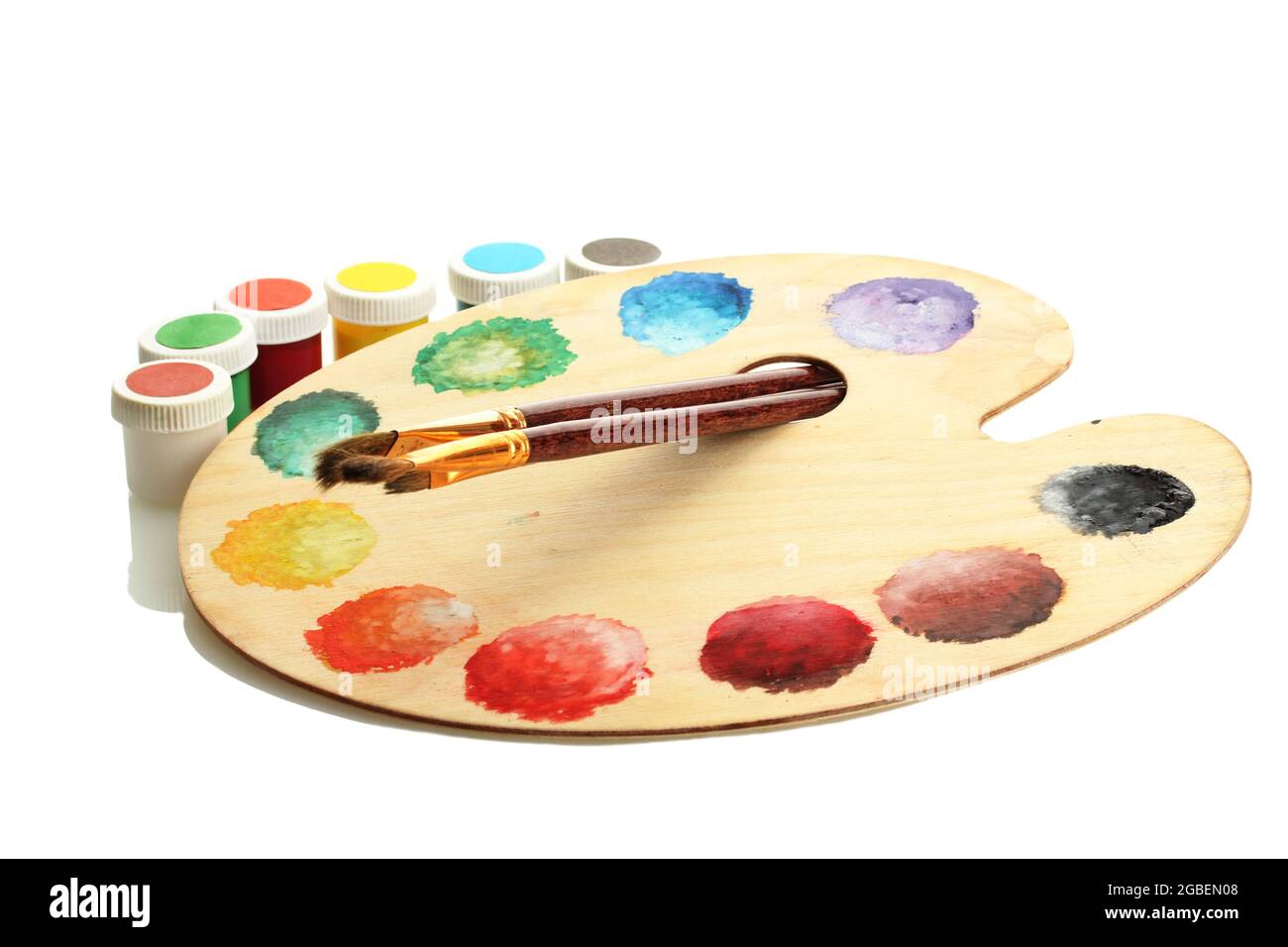 wooden art palette with paint and brushes isolated on white Stock Photo ...