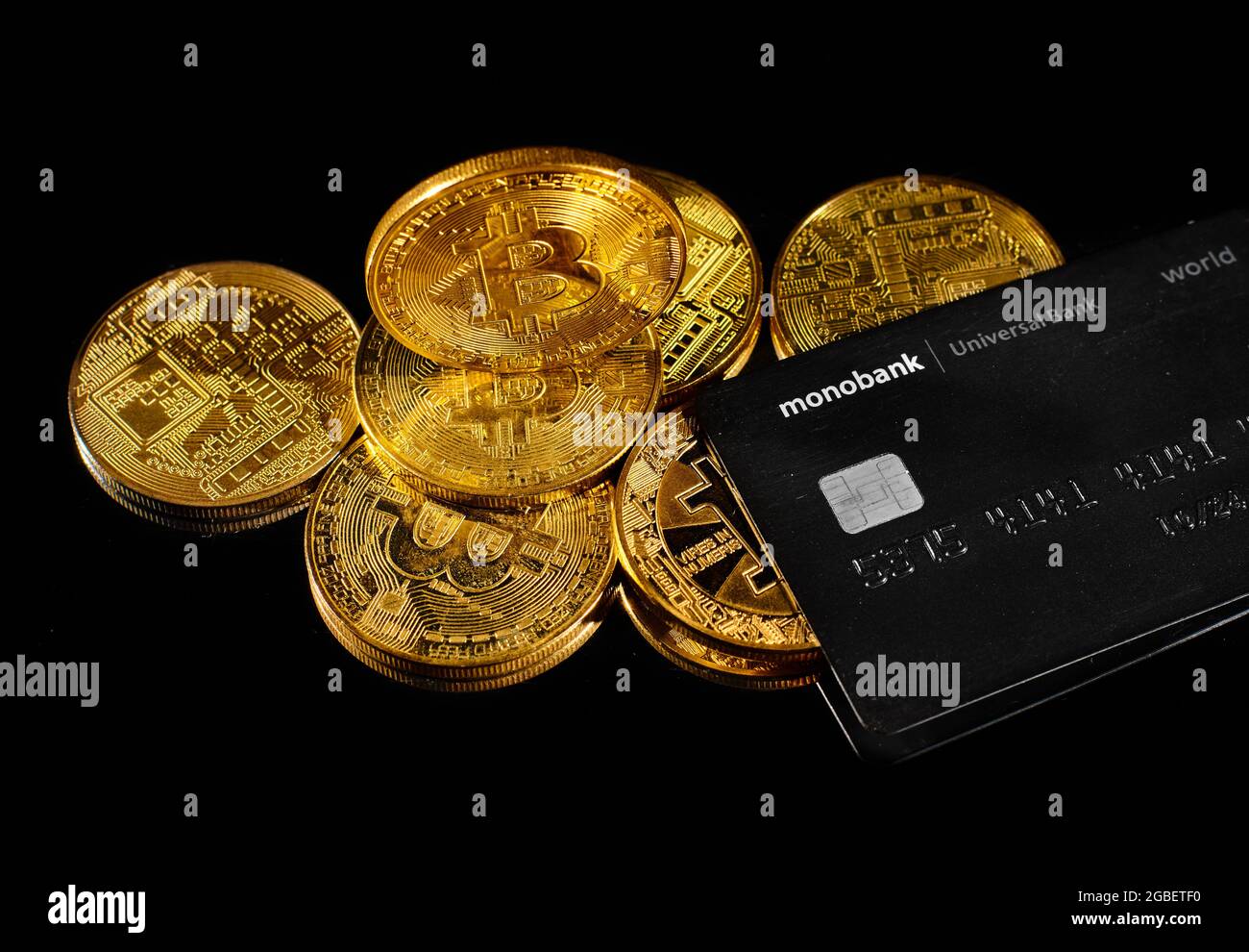 Lutsk, Ukraine - May 1, 2021: Golden coin with bitcoin logo and credit card  by monobank. Crypto currency BTC and bitcoin rewards card by Universal ban  Stock Photo - Alamy