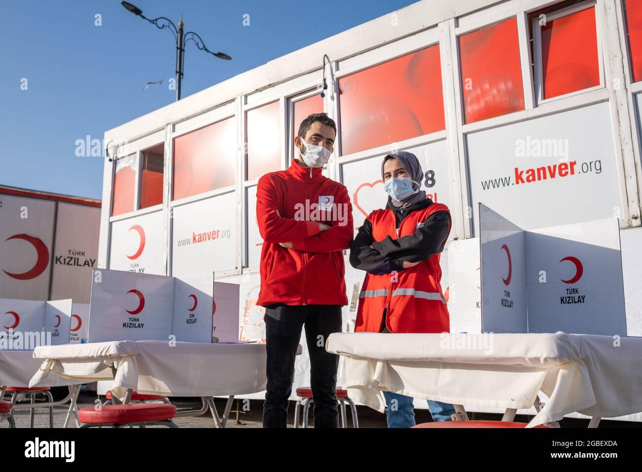 Eminonu, Istanbul, Turkey - 02.26.2021: male and female employees of Turkish Red Crescent (Turk Kizilay) in front of blood donation vehicle. Literal t Stock Photo