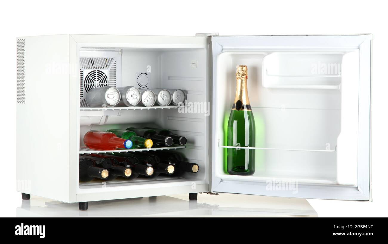 Mini fridge full of bottles of alcoholic beverages isolated on white