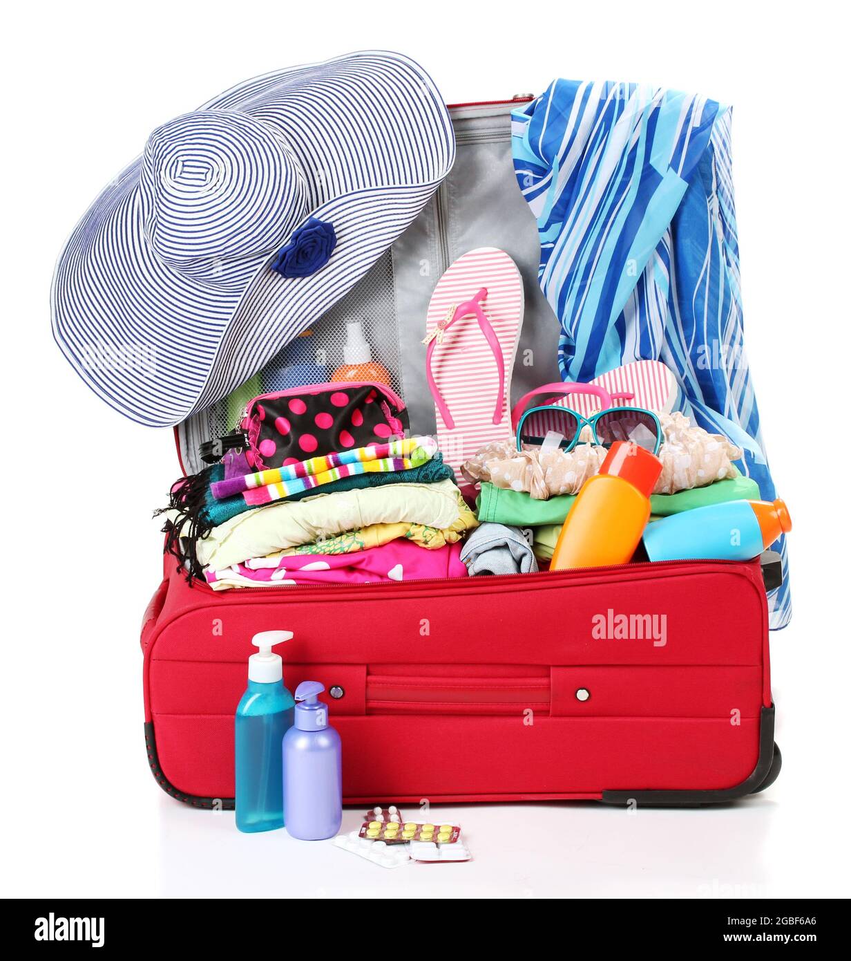 Red travel suitcase with personal belongings isolated on white Stock