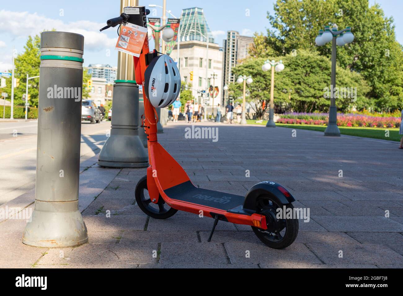 Ottawa Canada August 2 2021 Electric Scooter With Helmet For Rent On The Street Orange E Scooter Parked On The Sidewalk In Downtown Stock Photo Alamy