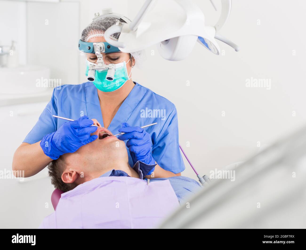 dentist professional filling teeth for man Stock Photo Alamy
