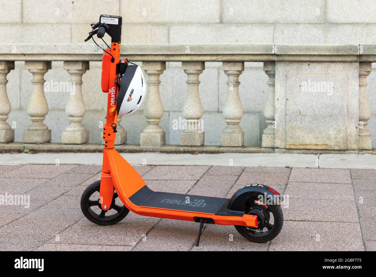 Ottawa, Canada August 2, 2021 Orange electric scooter with helmet