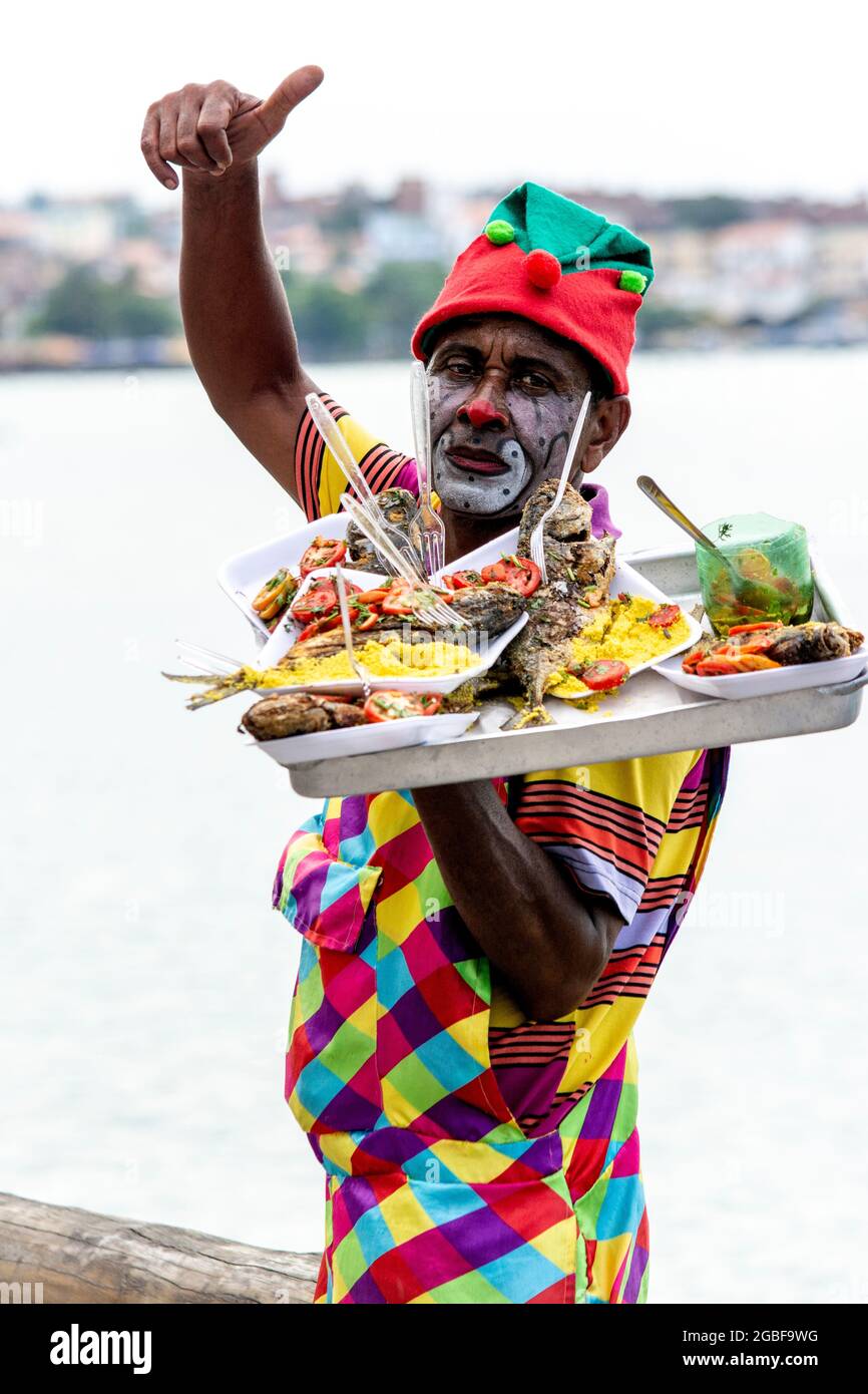Salvador, Bahia, Brazil - December 22, 2018: Friendly food seller dressed as a Clown. Stock Photo