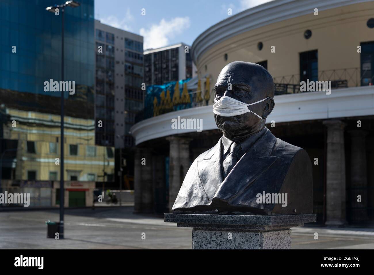 Salvador, Bahia, Brazil - May 27, 2020: Monument statue in Mercado Modelo square with protective mask on face. Stock Photo