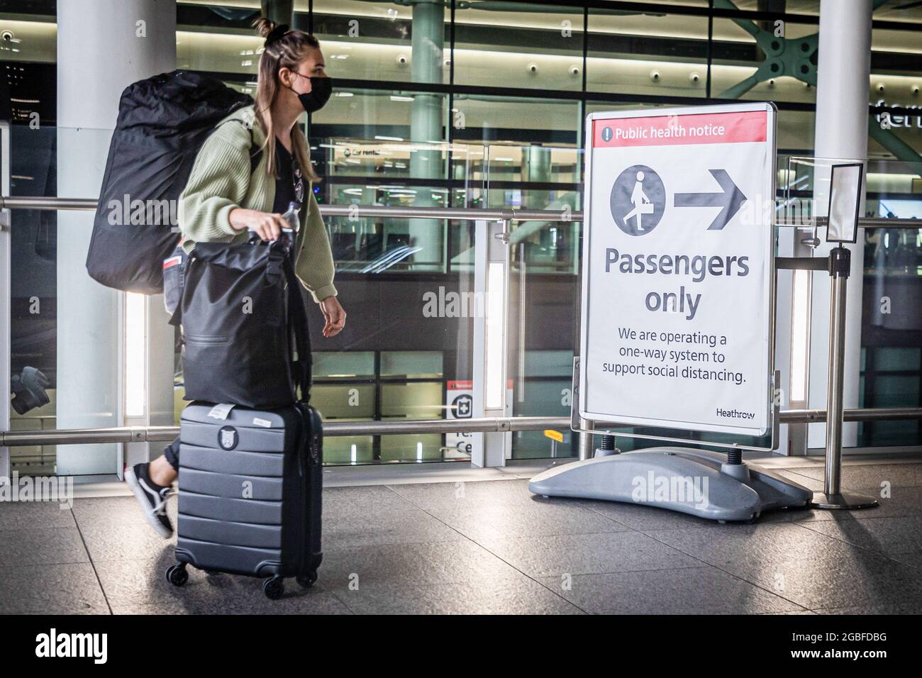 London, UK. 03rd Aug, 2021. A passenger wearing a face mask as a