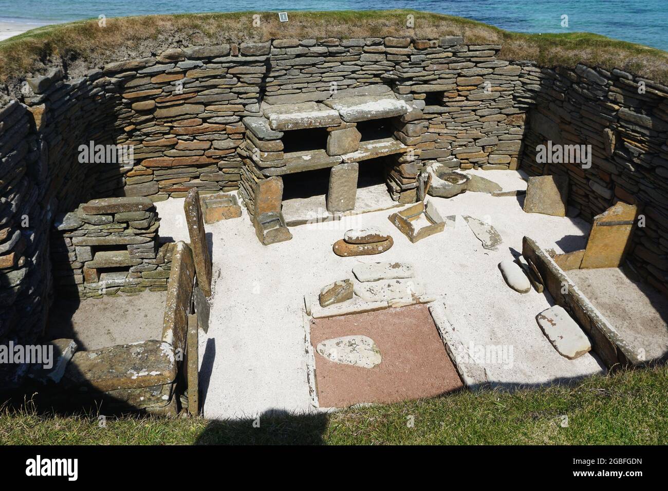 View into one of the restored ancient structures at Skara Brae, an ancient Neolithic village located on Scotland's Orkney Island. Stock Photo