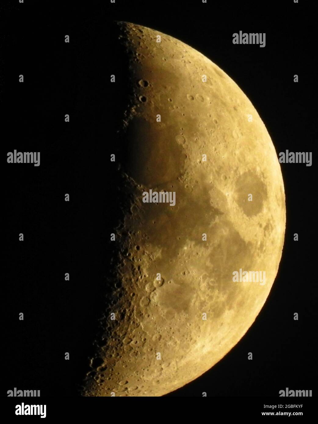 Vertically Split Moon Vertical shot of the partially visible moon with craters on black ...