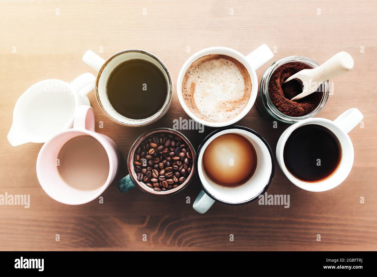 https://c8.alamy.com/comp/2GBFTRJ/multiple-coffee-cups-and-multicolored-mugs-with-americano-espresso-latte-and-cappuccino-milk-jar-roasted-coffee-beans-in-glass-bottle-wooden-spoo-2GBFTRJ.jpg