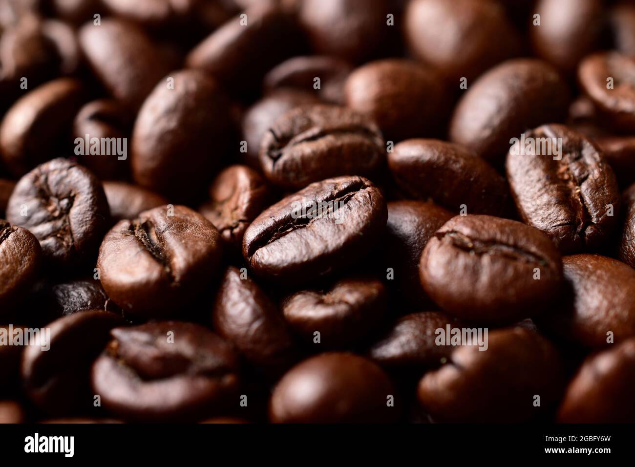 Roasted brown coffee beans texture background Stock Photo - Alamy