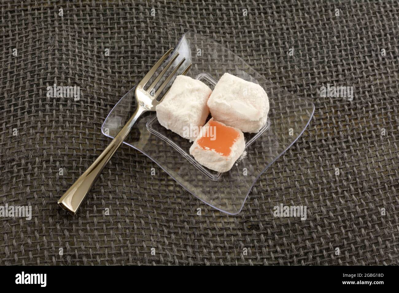 Greek prickly pear loukoumi pieces on small transparent snack plate