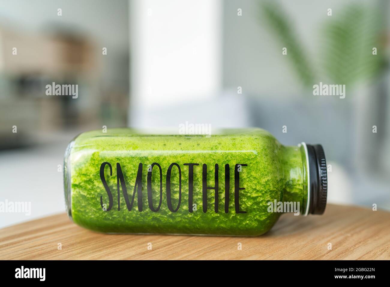 Green smoothie juice glass bottle eco-friendly health shop cafe. With word SMOOTHIE written on label Stock Photo
