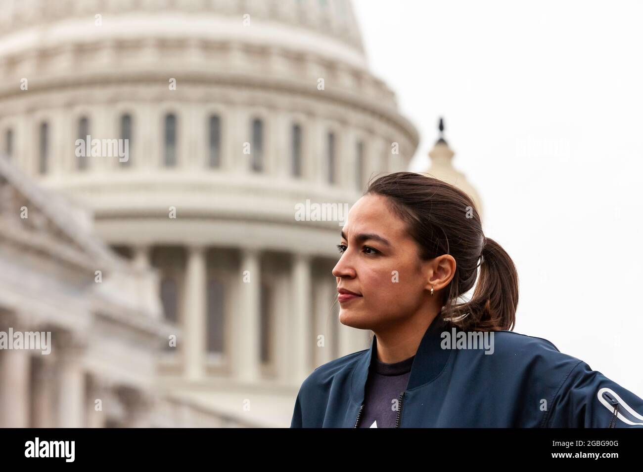 Congresswoman Alexandria Ocasio-Cortez (D-NY) listens as Congresswoman Cori Bush answers questions about her role in extending the pandemic eviction moratorium at a press conference announcing the new 60-day ban on evictions. Stock Photo