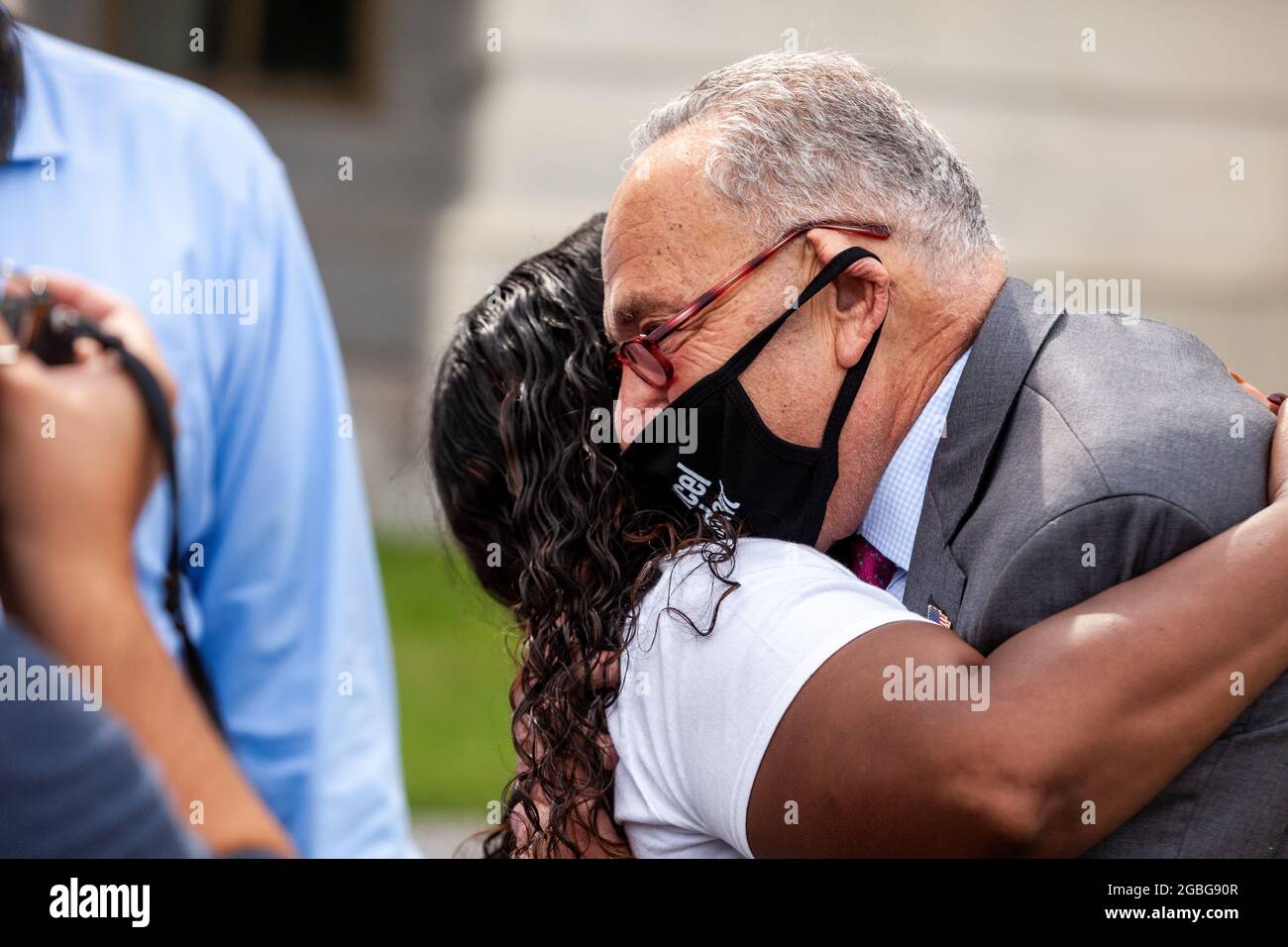 Washington, DC, USA, 3 August 2021.  Pictured: Senate Majority Leader Chuck Schumer (D-NY) hugs meets with Representative Cori Bush (D-MO) and delivers the good news that her protest against the end of the pandemic eviction moratorium on the Capitol steps has succeeded.  Credit: Allison Bailey / Alamy Live News Stock Photo