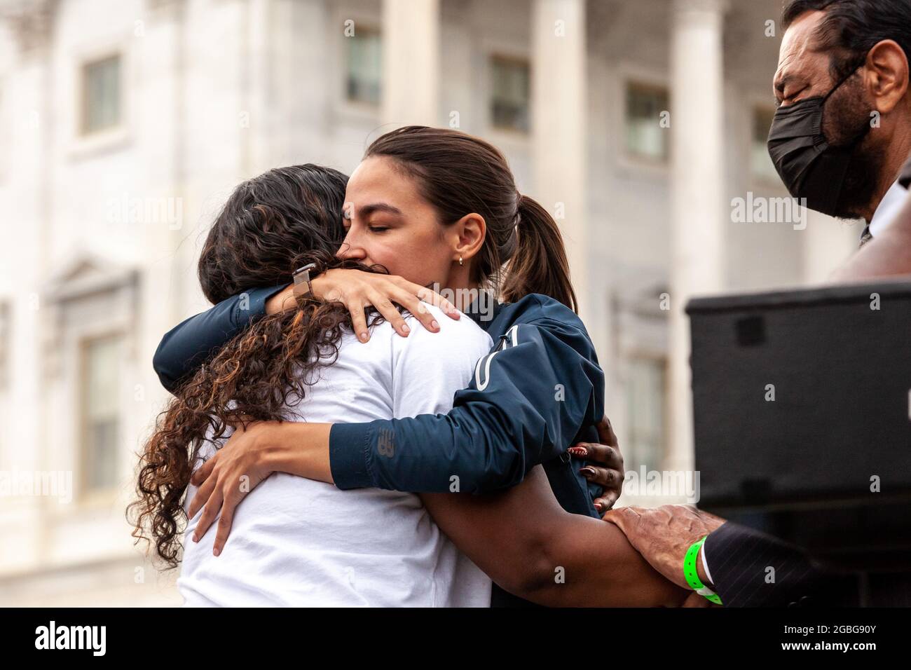 Washington, DC, USA, 3 August 2021.  Pictured: Congresswoman Cori Bush (D-MO) gets a hug from Alexandria Ocasio-Cortez (D-NY) at a press conference announcing the Center for Disease Control’s new 60-day pandemic eviction moratorium at the Capitol.  Credit: Allison Bailey / Alamy Live News Stock Photo