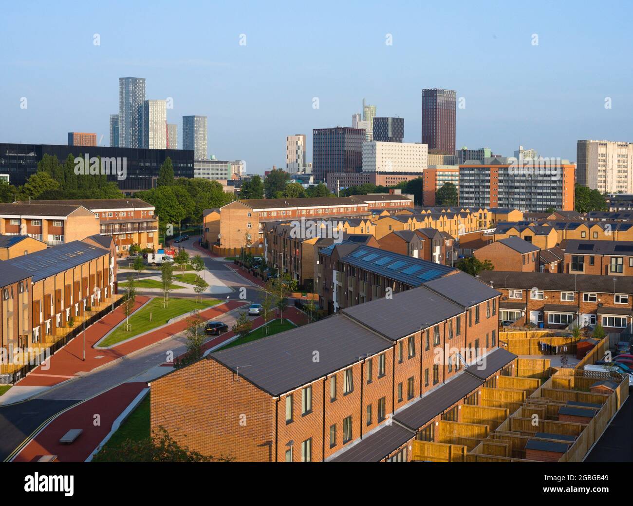 A high level view of new skyscrapers with new houses in the foreground in central Manchester, England, United Kingdom, seen from the Ardwick area of the city to the South of the city centre. Stock Photo