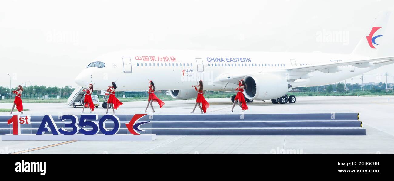 Beijing, China. 4th Aug, 2021. A band performs in front of an Airbus A350 aircraft delivered to China Eastern Airlines at the Airbus Tianjin Widebody Completion and Delivery Center in north China's Tianjin, July 21, 2021. TO GO WITH XINHUA HEADLINES OF AUG. 4, 2021 Credit: Zhang Yuwei/Xinhua/Alamy Live News Stock Photo