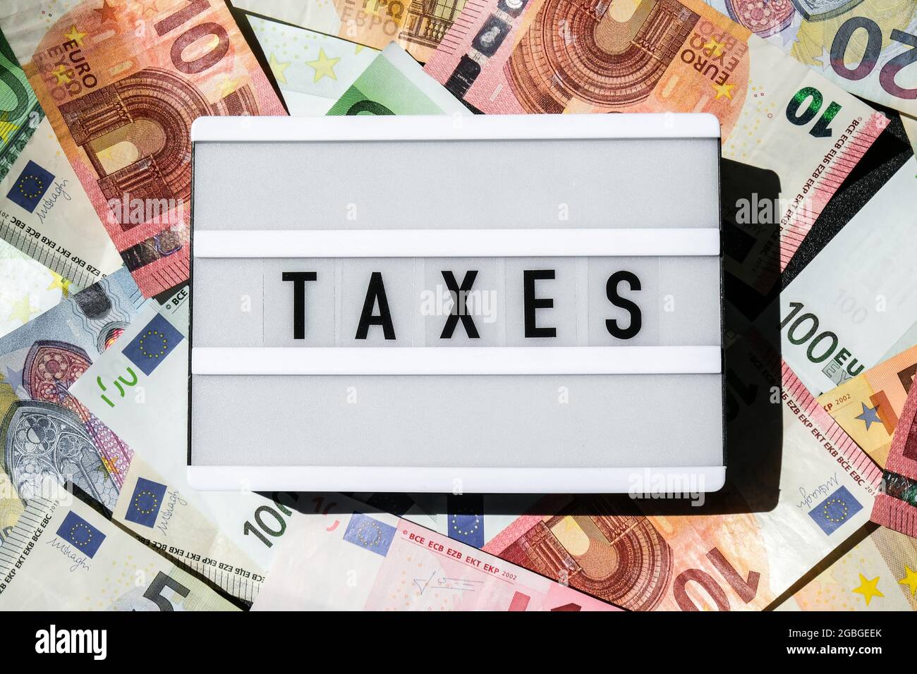 Lightbox board with word TAXES in black letters around Euro banknotes. Tax  payment and filing concept. Money, Business, finance, investment, saving  Stock Photo - Alamy