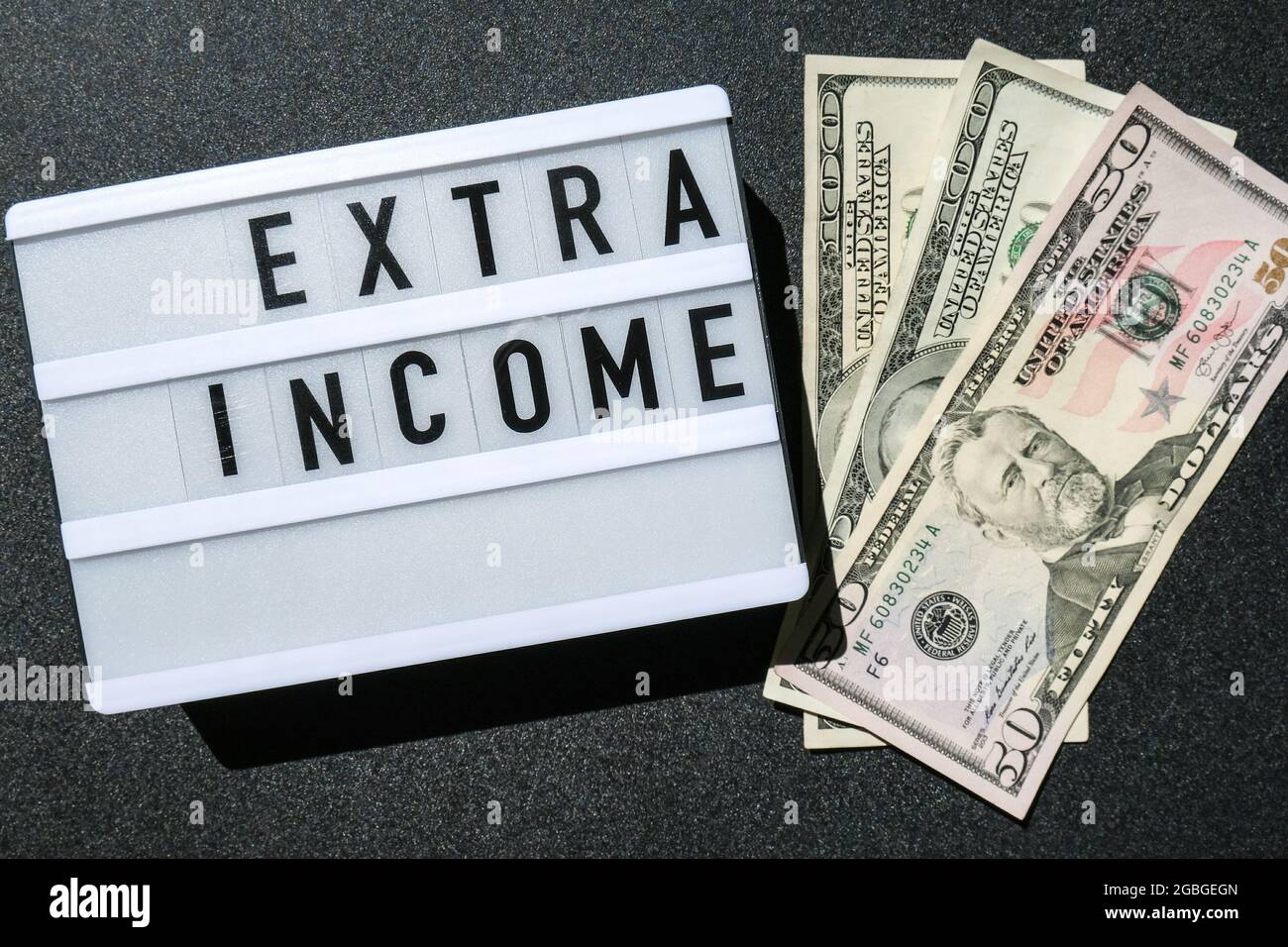Lightbox Board With Word Extra Income In Black Letters Around Us Dollar Banknotes Money Business Finance Investment Saving Stock Photo Alamy