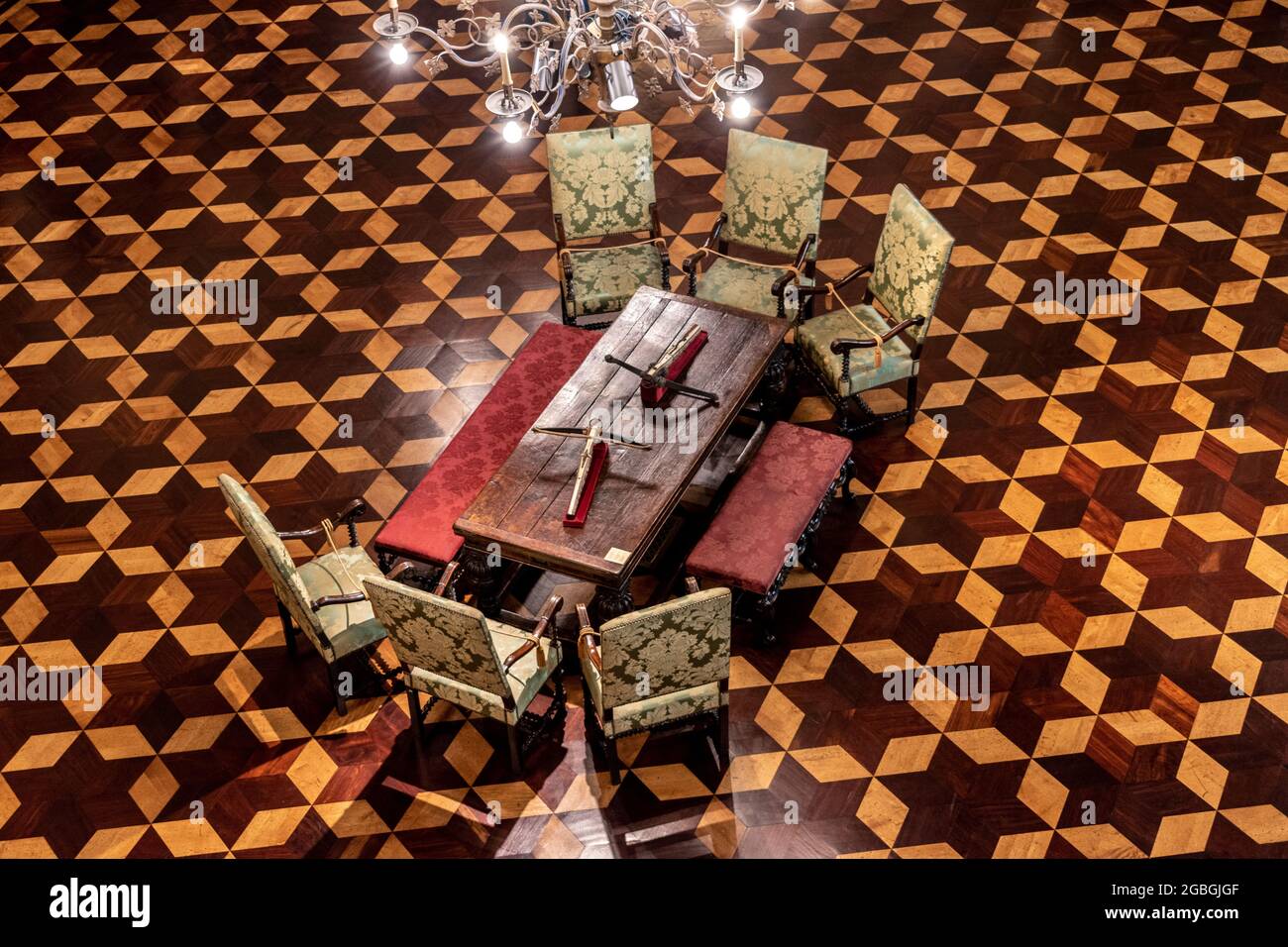 High angle view of two crossbows on a table surrounded by antique chairs at the Museum of Decorative Arts in Buenos Aires, Argentina Stock Photo
