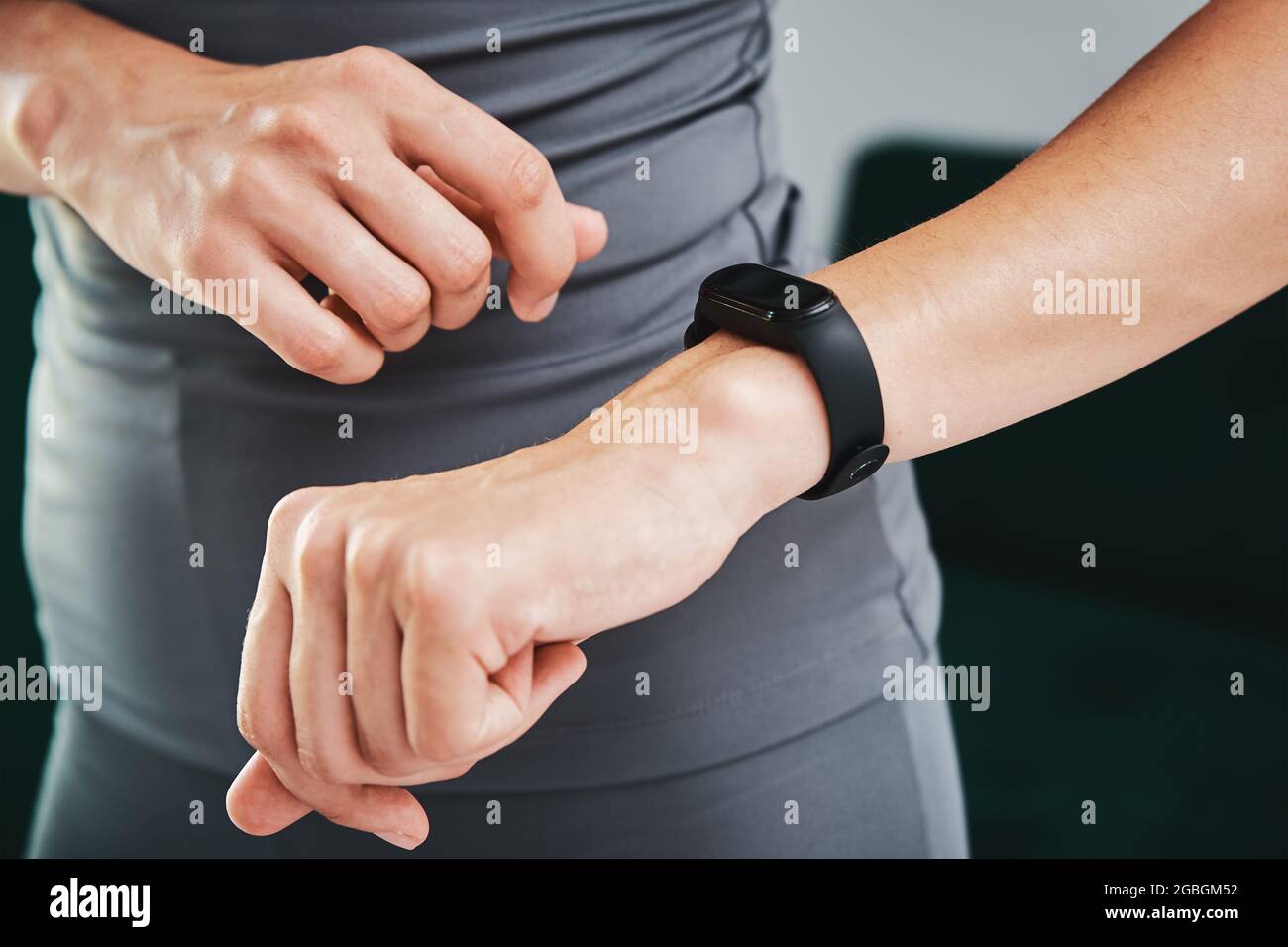 Woman doing exercise and using fitness tracker. Sport activity at home Stock Photo