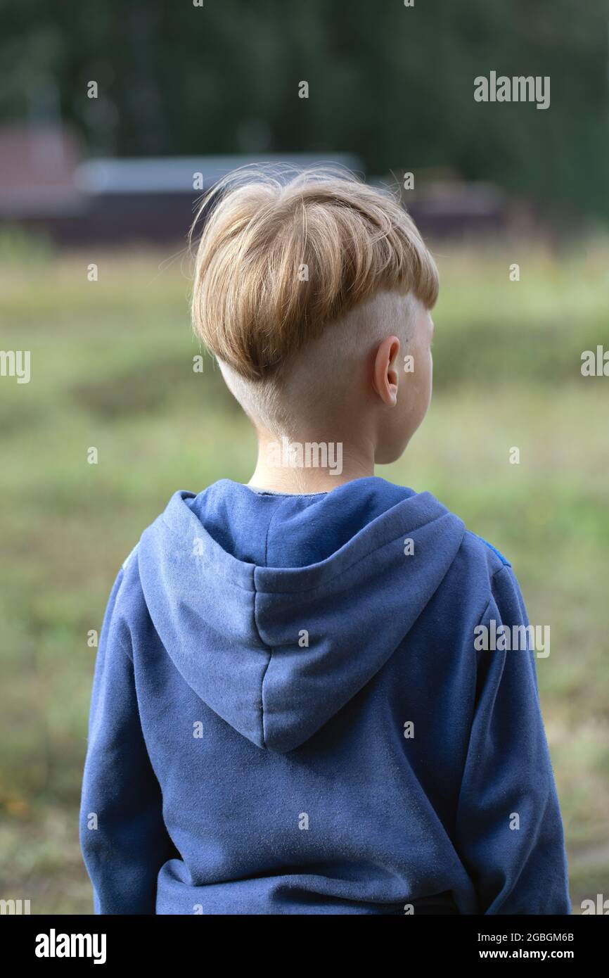 Portraits from back of boy with fashionable hairstyle in sports jacket on  blurred natural background. Model haircut or after visit to hairdresser.  Wal Stock Photo - Alamy