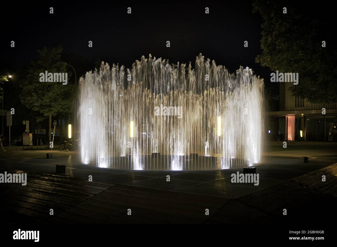 Round water fountain at night Stock Photo - Alamy