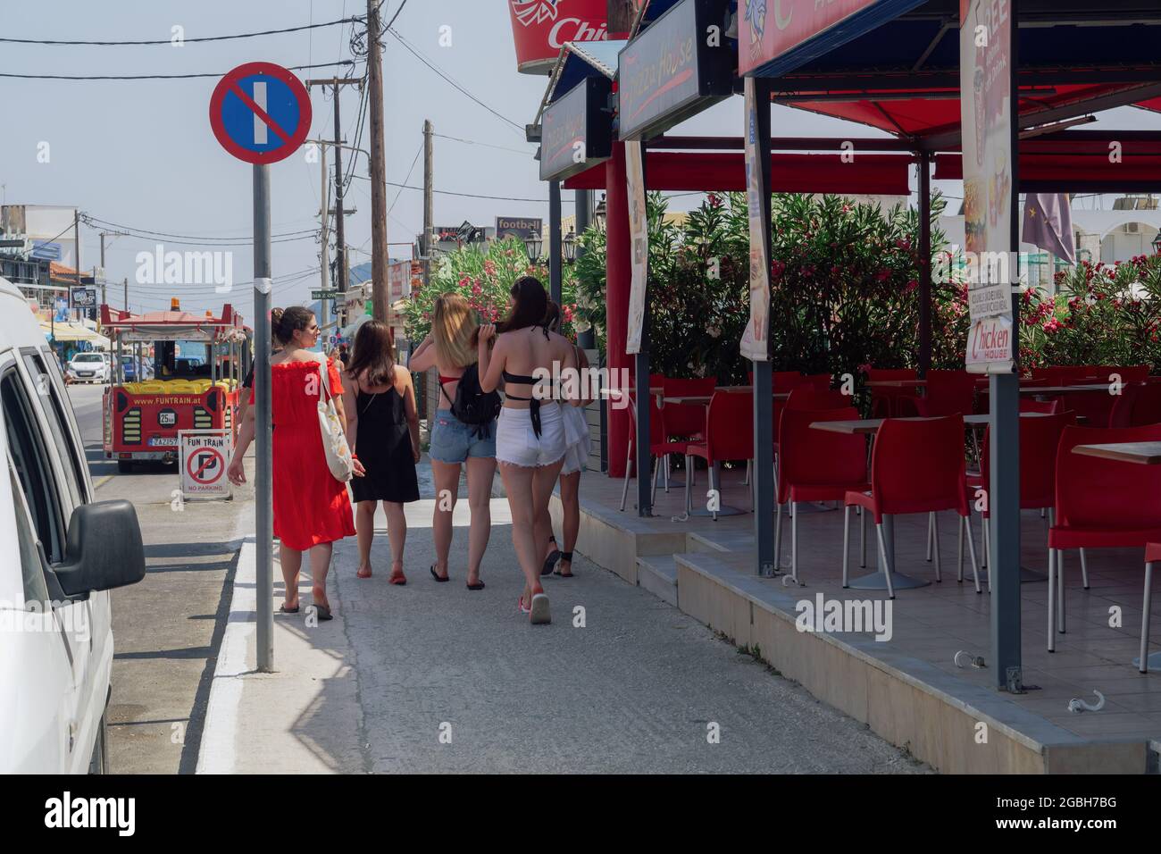 Zakynthos, Greece unidentified tourists walking the main Laganas road. Day  view of people in beach clothes next to a fast-food restaurant in the  Ionian islands Stock Photo - Alamy