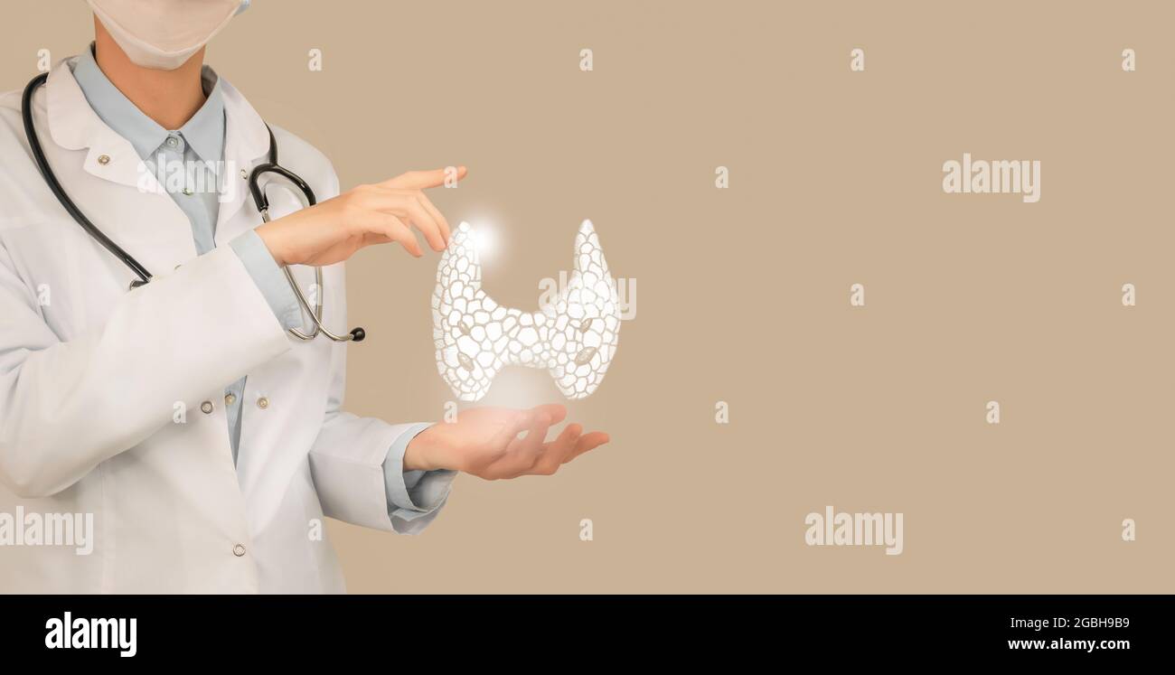 Female doctor holding virtual Thyroid Gland in hand. Handrawn human organ, copy space on right side, beige color. Healthcare hospital service Stock Photo