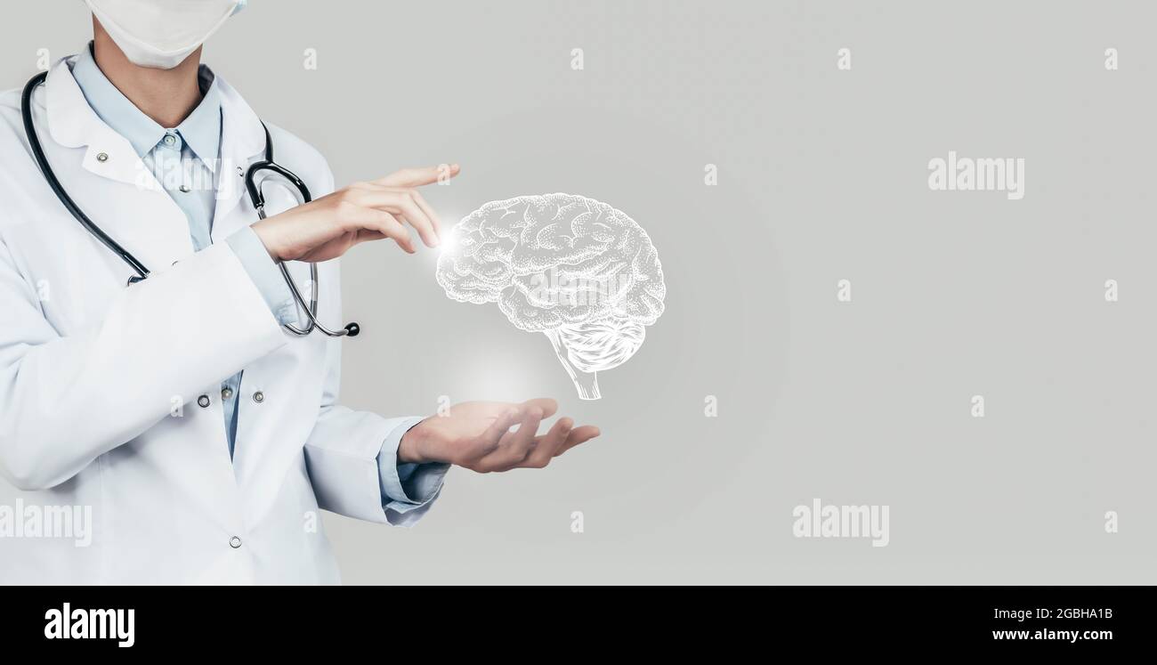 Female doctor holding virtual Brain in hand. Handrawn human organ, copy space on right side, grey hdr color. Healthcare / scientific technologies conc Stock Photo
