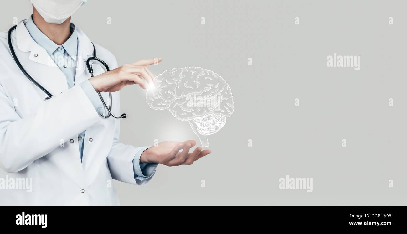 Female doctor holding virtual Brain in hand. Handrawn human organ, copy space on right side, grey hdr color. Healthcare / scientific technologies conc Stock Photo