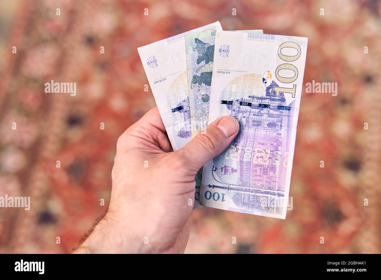 Georgian national currency is Lari. Georgian money in a man's hand. Stock Photo