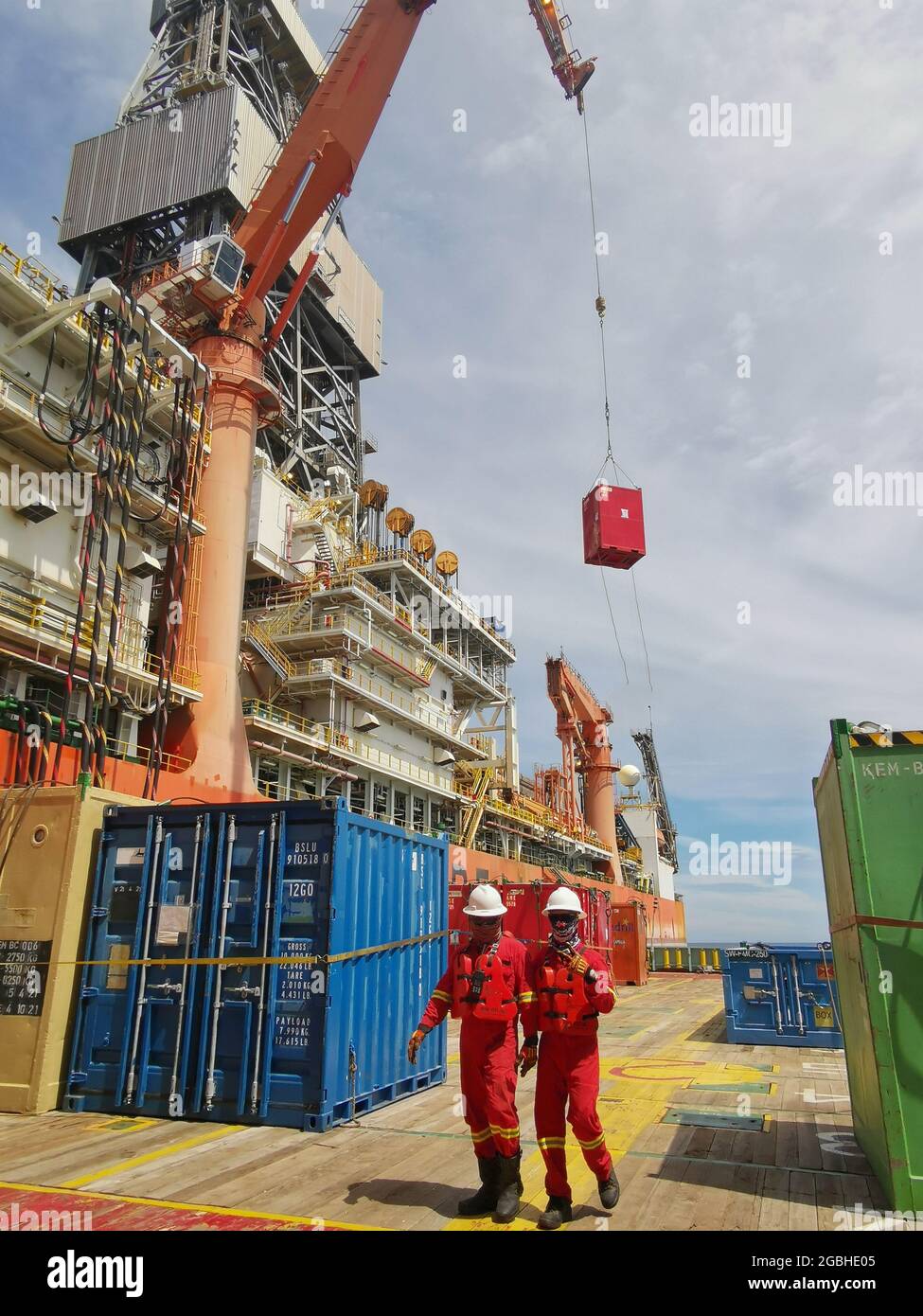 MPSV or multi purpose supply vessel alongside with drilling vessel to supply cargo for drilling well operation Stock Photo