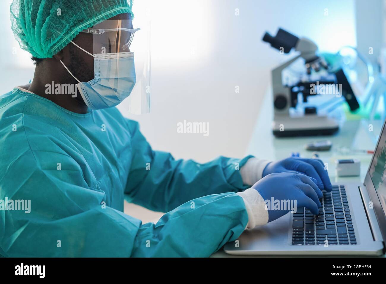 Computer Medical Mask African american doctor man using computer laptop wearing safety mask ...