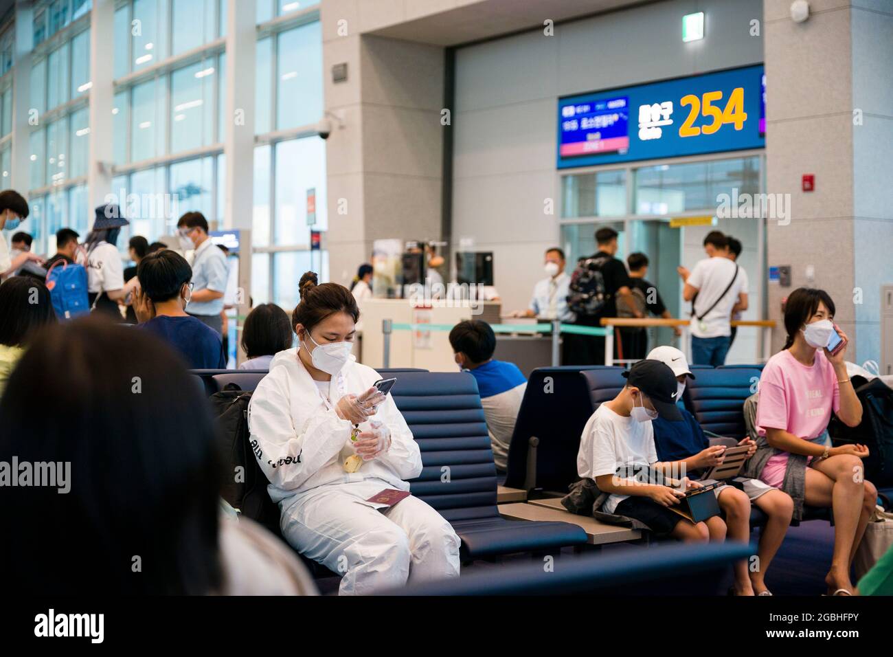 Bucheon, Bucheon, South Korea. 4th Aug, 2021. A passenger wearing a clean suit waits to board her flight at Incheon International Airport. (Credit Image: © Jintak Han/ZUMA Press Wire) Stock Photo