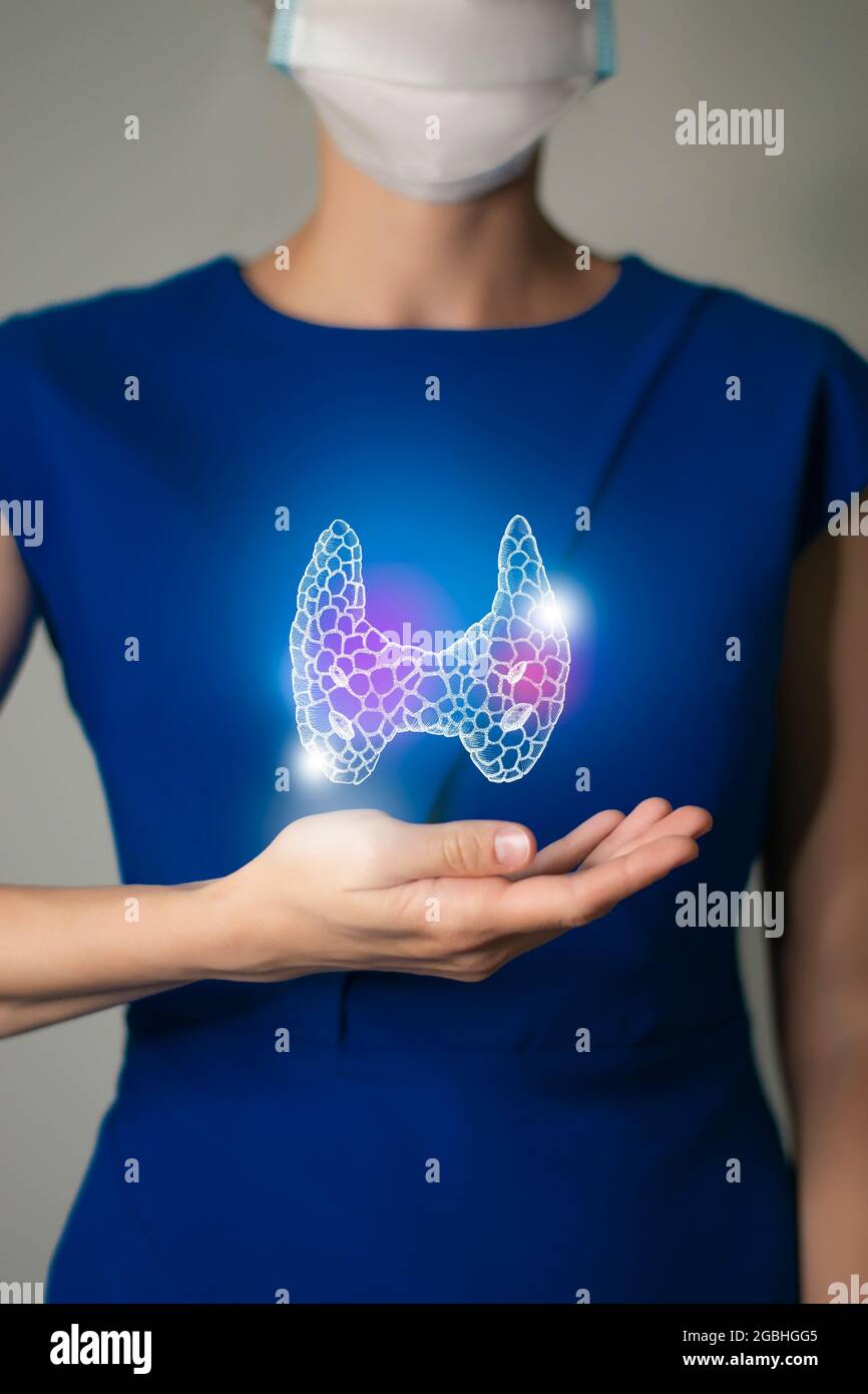 Woman in blue clothes holding virtual Thyroid Gland in hand. Handrawn human organ, detox and healthcare, healthcare hospital service concept stock pho Stock Photo