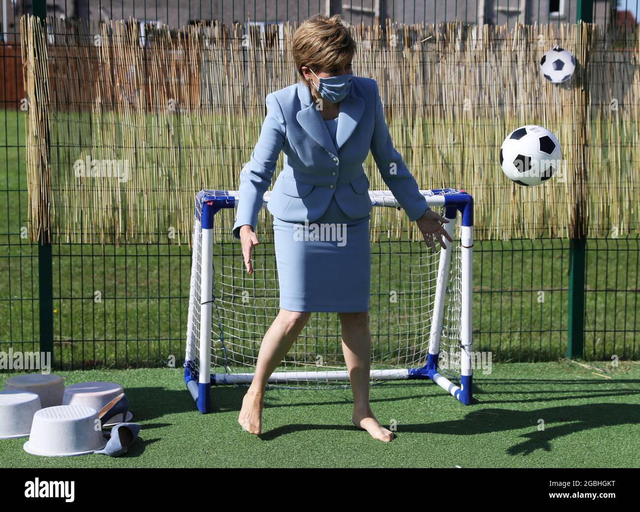 First Minister Nicola Sturgeon plays football during a visit to the