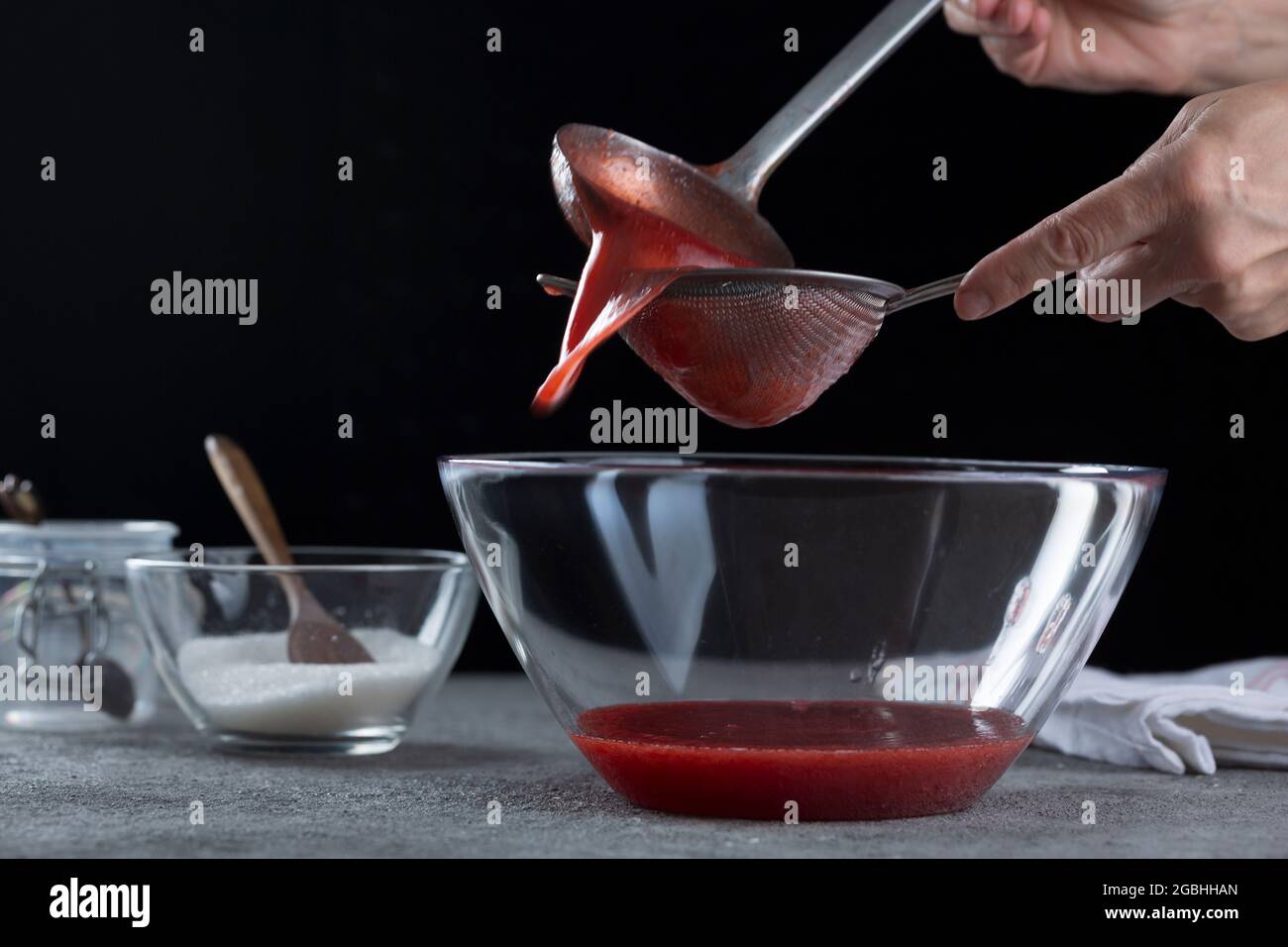 straining fruit that is softened by cooking, through a muslin bag