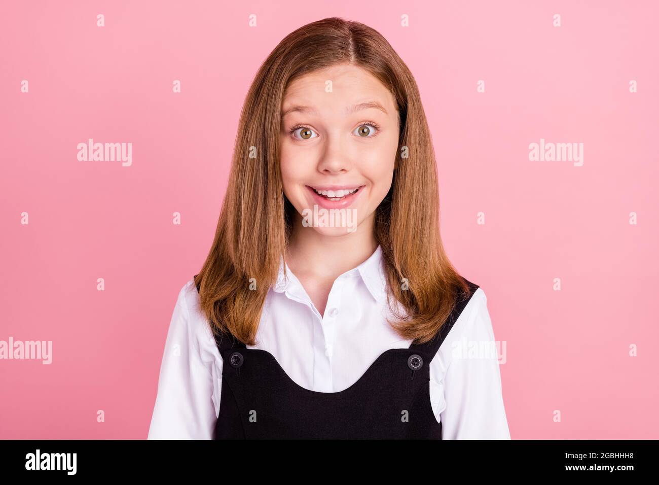 Photo of excited funny school girl wear black white uniform big eyes
