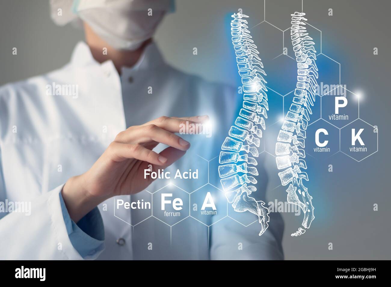 Essential nutrients for Spine health including Magnesium, Vitamin B12, Calcium, Ferrum.Blurred portrait of doctor holding highlighted blue Spine. Stock Photo