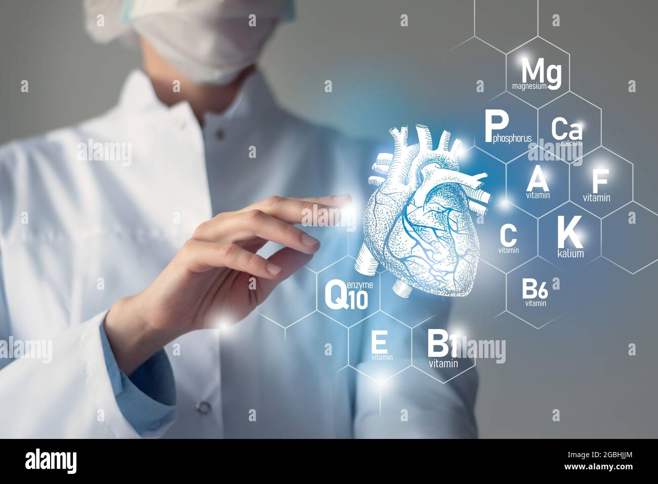 Essential nutrients for Heart health including Q10, Calcium, Magnesium, Vitamin F.Blurred portrait of doctor holding highlighted blue Heart. Stock Photo